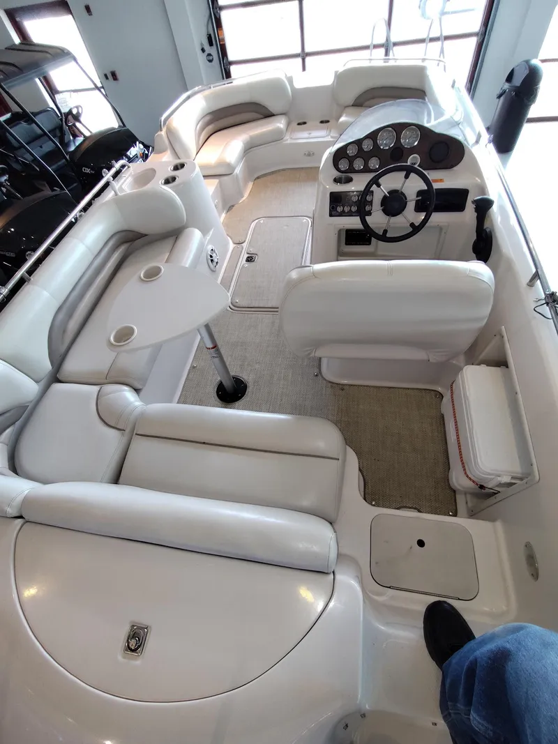 Slide: The Image of Interior view of a 2001 Hurricane 201GS boat with white seating and steering console. - 15