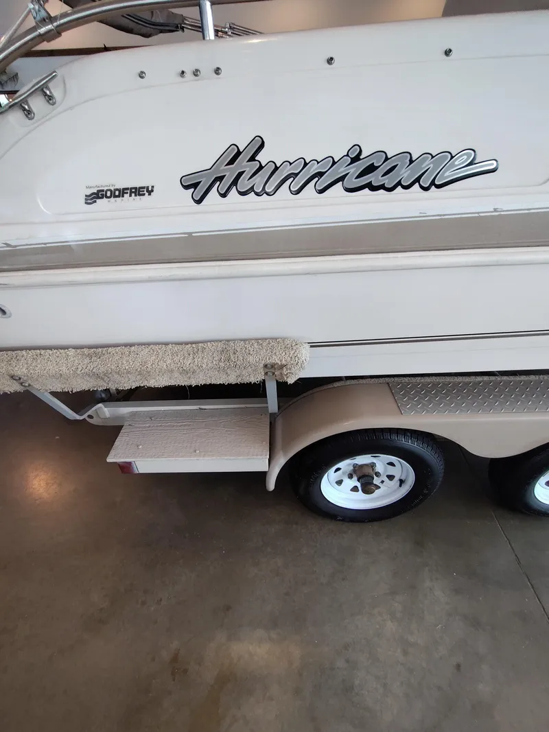 Slide: The Image of 2001 Hurricane 201GS boat on trailer, featuring Godfrey logo and carpeted step. - 17