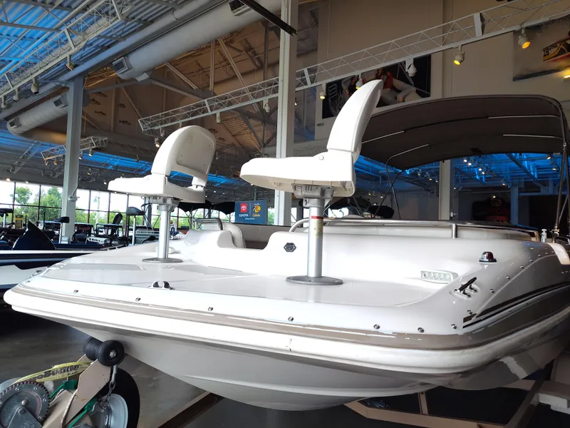 Slide: The Image of 2001 Hurricane 201GS boat displayed in a showroom with elevated seating. - 20