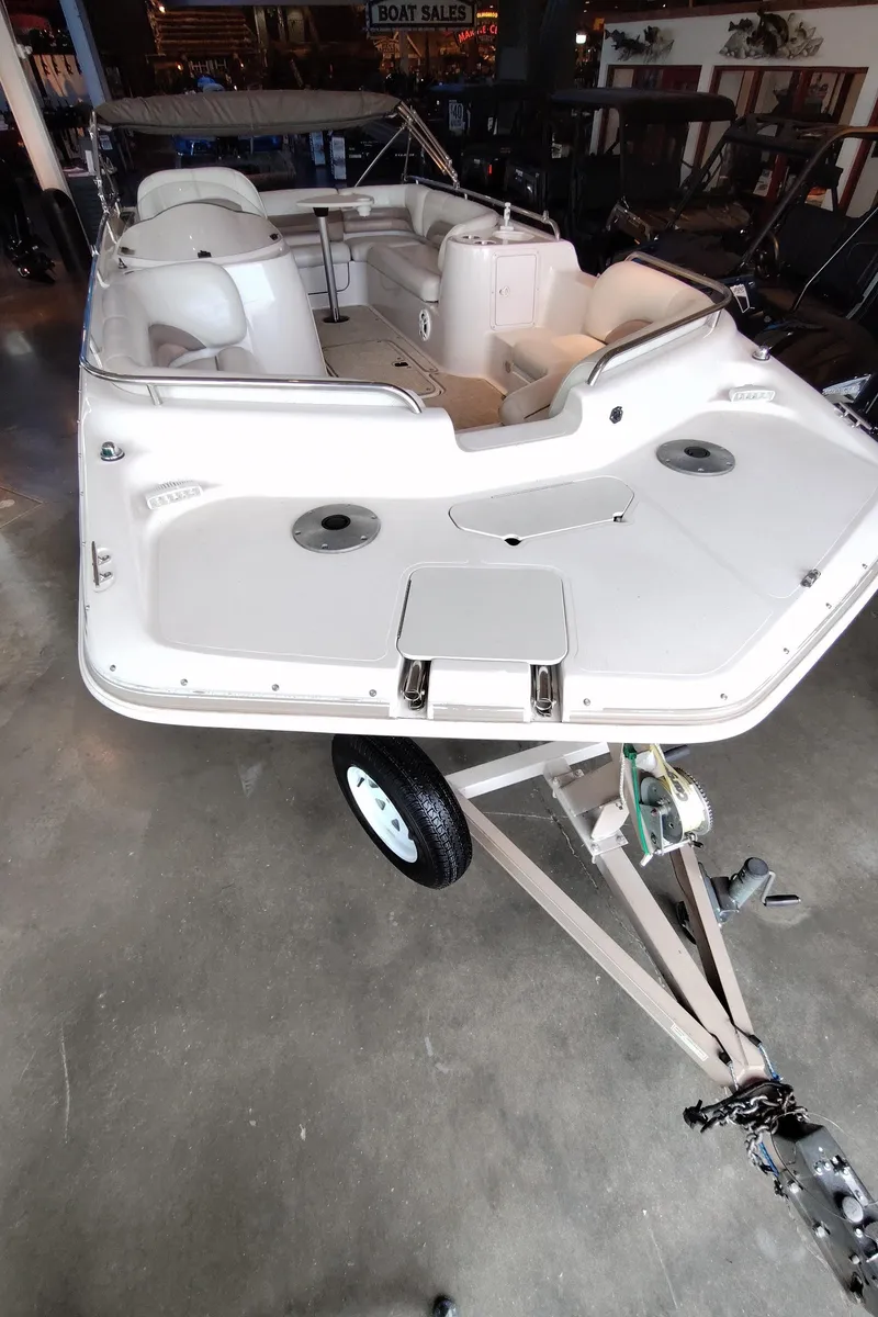 Slide: The Image of 2001 Hurricane 201GS boat on trailer in showroom, featuring spacious seating and sleek design. - 3
