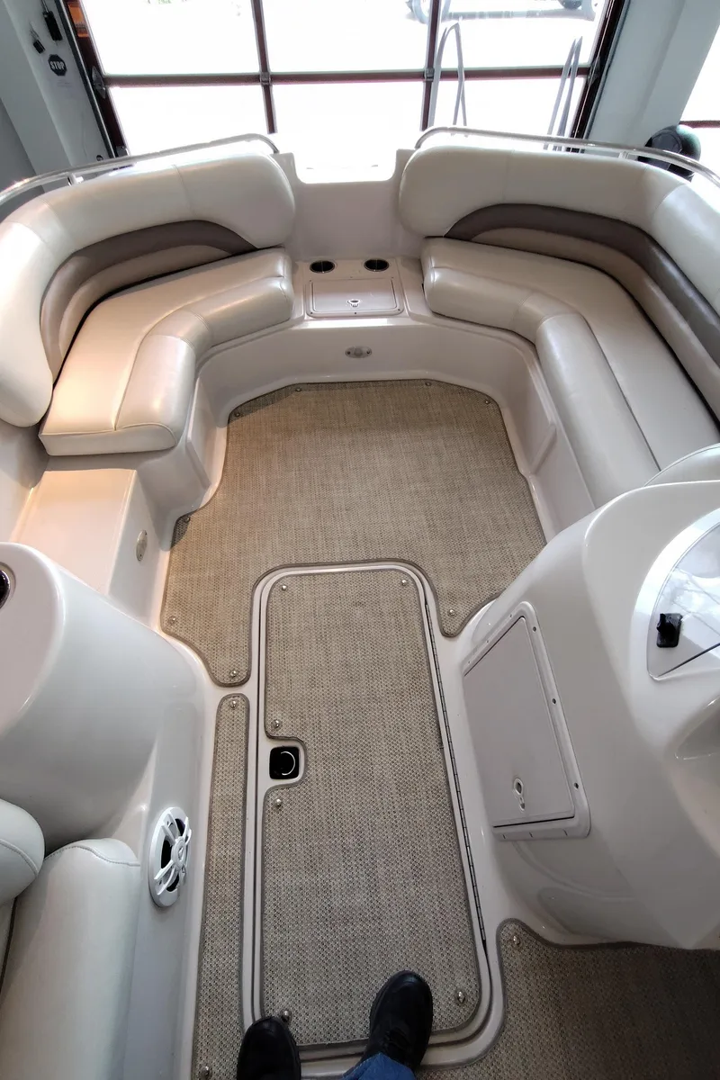 Slide: The Image of Interior of a 2001 Hurricane 201GS boat with beige seating and carpet flooring. - 6