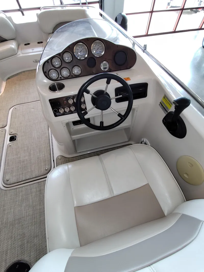 Slide: The Image of 2001 Hurricane 201GS boat cockpit with steering wheel and instrument panel. - 8