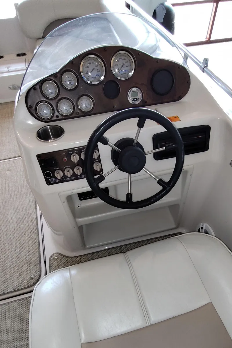 Slide: The Image of 2001 Hurricane 201GS boat dashboard with steering wheel and instrument panel. - 9