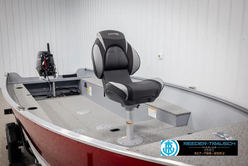 Slide: The Image of 2025 Lund 1600 Fury Heritage Edition boat interior with swivel seat and motor. - 11