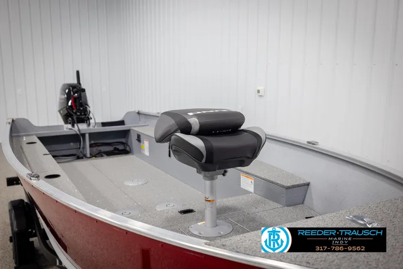 Slide: The Image of 2025 Lund 1600 Fury Heritage Edition boat interior with seating and motor, displayed indoors. - 12