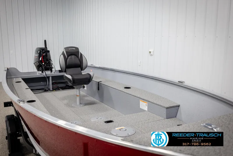 Slide: The Image of 2025 Lund 1600 Fury Heritage Edition boat with seating and motor, displayed indoors. - 13