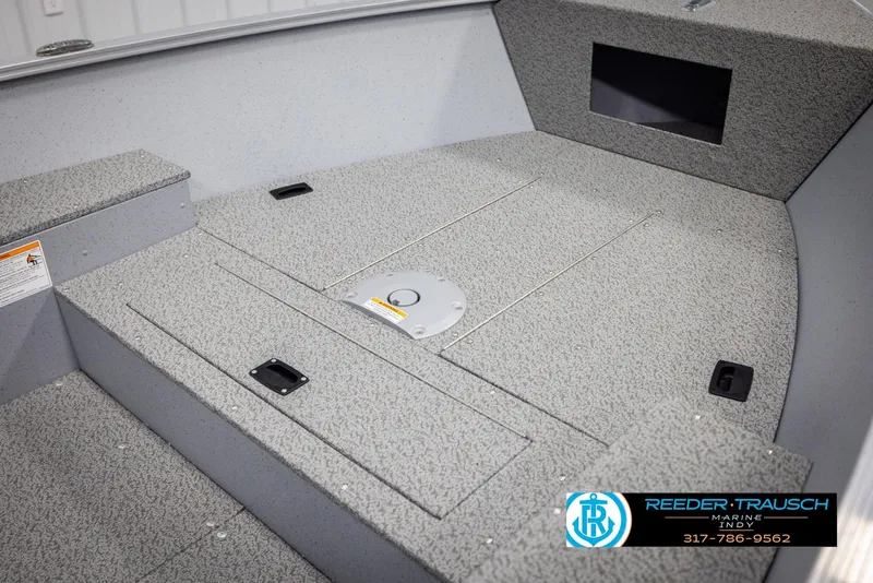 Slide: The Image of 2025 Lund 1600 Fury Heritage Edition boat interior with textured flooring and storage compartments. - 14