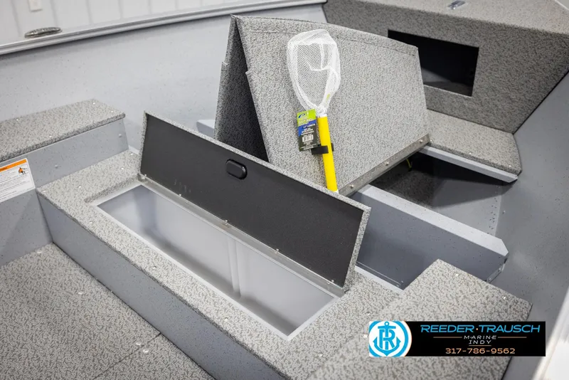 Slide: The Image of 2025 Lund 1600 Fury Heritage Edition boat interior with storage compartment and fishing net. - 15