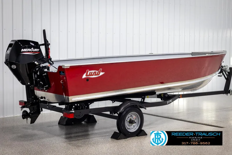 Slide: The Image of 2025 Lund 1600 Fury Heritage Edition boat with Mercury engine on trailer, displayed indoors. - 4