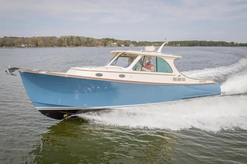 Slide: The Image of 2018 Hinckley Picnic Boat MKII cruising on a calm lake. - 1