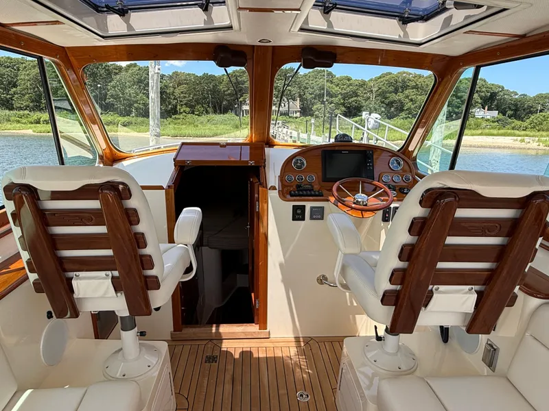 Slide: The Image of Interior of 2018 Hinckley Picnic Boat MKII with wooden helm and leather seats. - 13