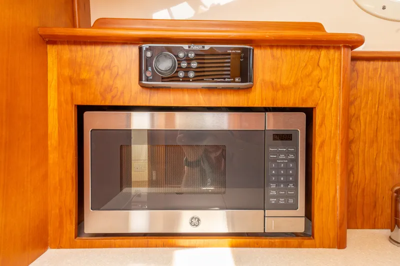 Slide: The Image of Microwave and stereo system in 2018 Hinckley Picnic Boat MKII interior. - 18