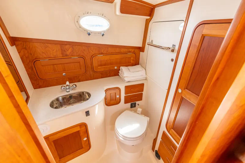 Slide: The Image of 2018 Hinckley Picnic Boat MKII bathroom with wood accents and modern fixtures. - 19