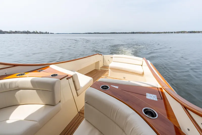 Slide: The Image of 2018 Hinckley Picnic Boat MKII cruising on calm waters, featuring luxurious seating and wooden accents. - 7