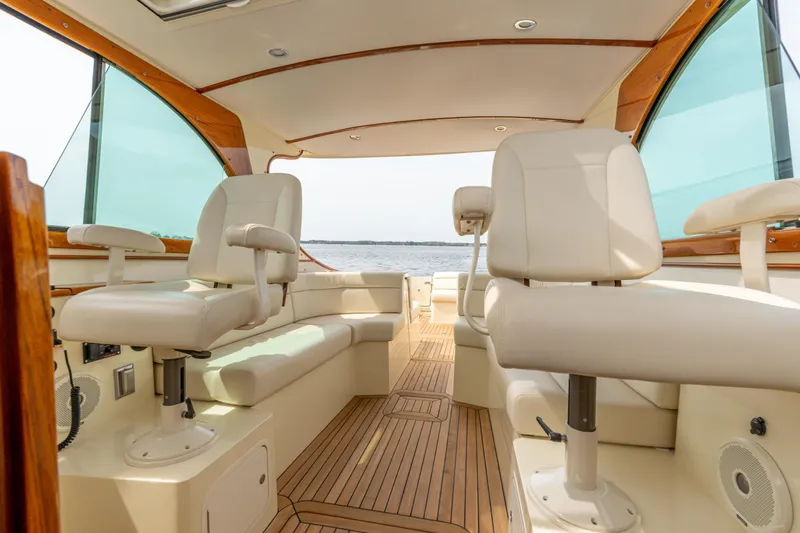 Slide: The Image of Interior of 2018 Hinckley Picnic Boat MKII with elegant seating and wooden flooring. - 9