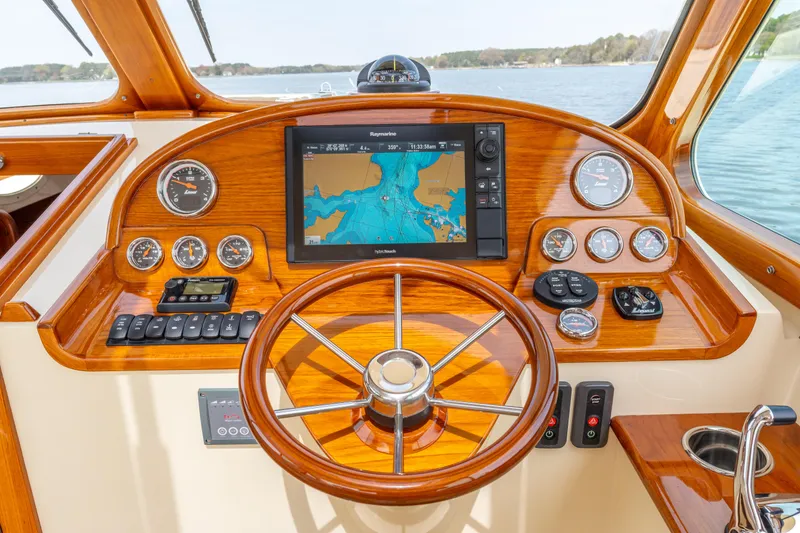 Slide: The Image of Helm of 2018 Hinckley Picnic Boat MKII with navigation display and wooden steering wheel. - 12