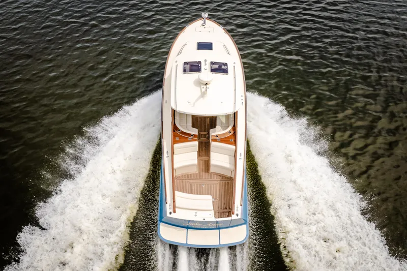 Slide: The Image of 2018 Hinckley Picnic Boat MKII cruising on water, aerial view. - 2