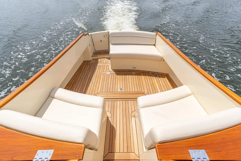 Slide: The Image of Hinckley Picnic Boat MKII 2018, elegant deck with cushioned seating on water. - 4