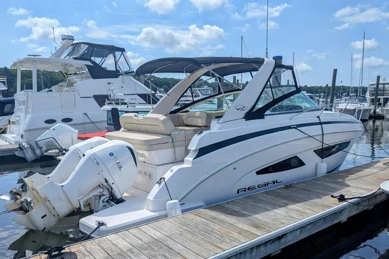 Slide: The Image of 2018 Regal 33 XO boat docked at marina with Yamaha outboard engines. - 2