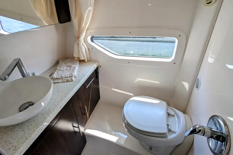 Slide: The Image of Luxurious bathroom in 2018 Regal 33 XO yacht with modern fixtures and window view. - 23
