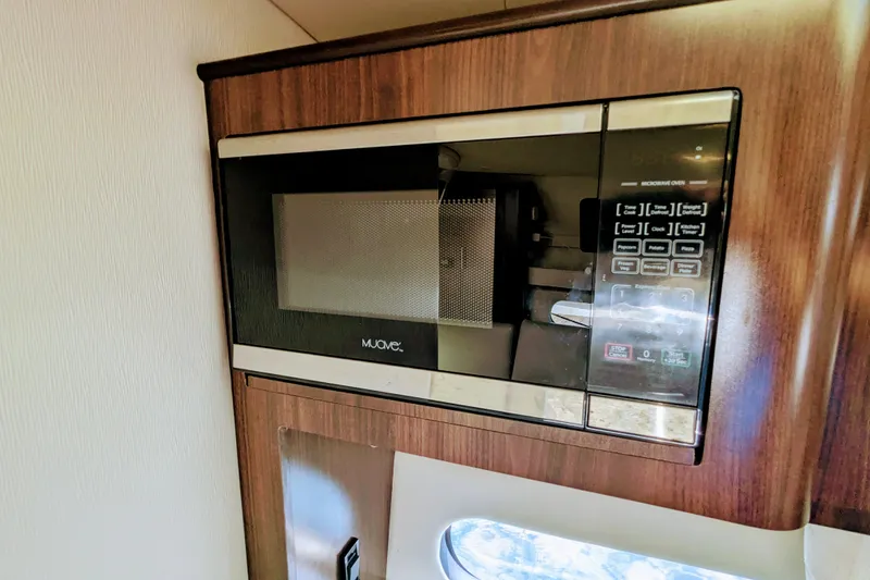 Slide: The Image of Built-in microwave in 2018 Regal 33 XO boat interior. - 27