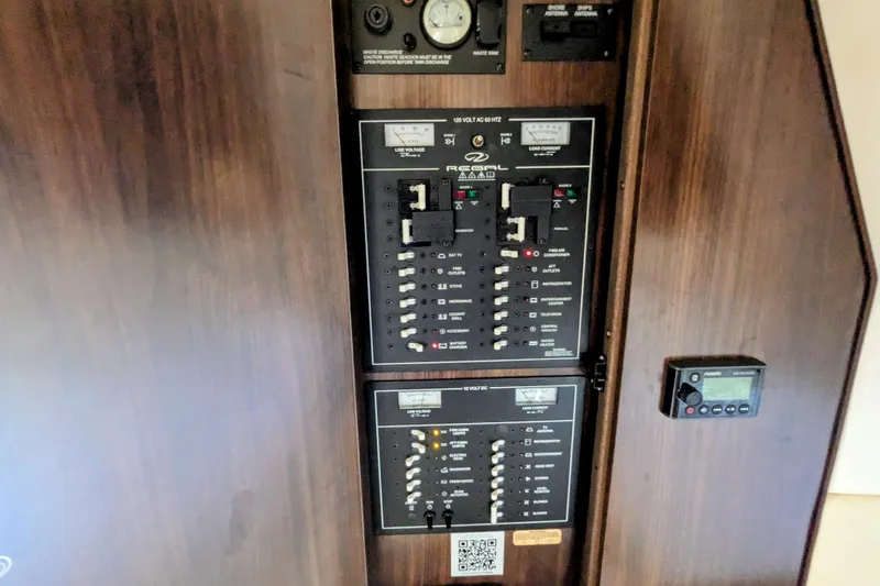 Slide: The Image of Electrical control panel of a 2018 Regal 33 XO boat, featuring various switches and gauges. - 29