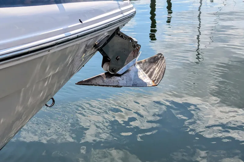 Slide: The Image of 2018 Regal 33 XO boat anchor above water, reflecting sunlight. - 30