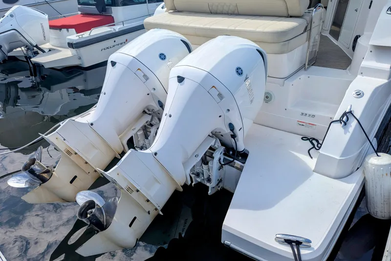 Slide: The Image of 2018 Regal 33 XO boat with dual outboard engines docked at marina. - 6