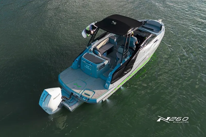 Slide: The Image of 2025 NX Boats NX260 EVOLUTION cruising on water, featuring sleek design and powerful outboard motor. - 3