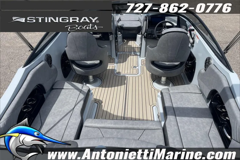 Slide: The Image of 2026 Stingray 23 OSX boat interior with gray seating and modern dashboard. - 12