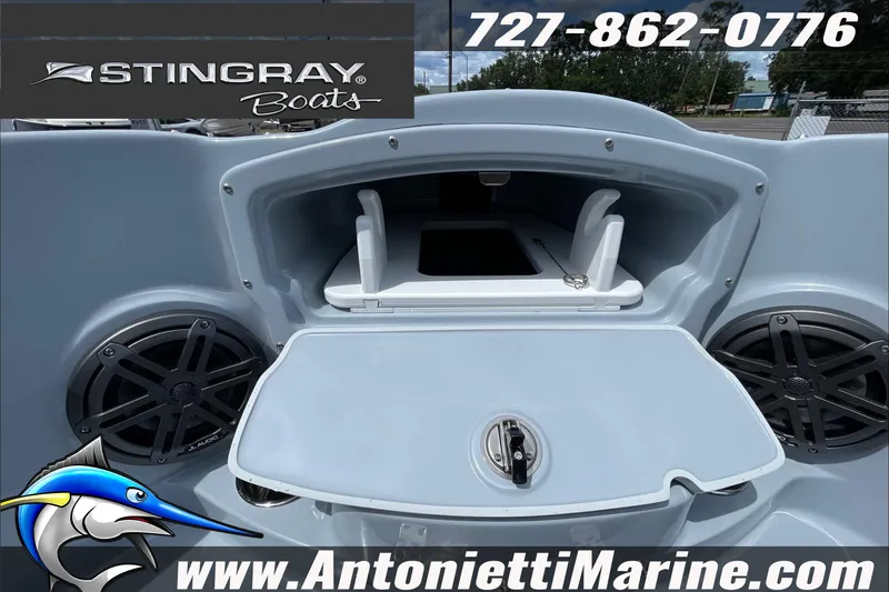 Slide: The Image of 2026 Stingray 23 OSX boat interior with storage compartment and speakers, featuring Antonietti Marine branding. - 18