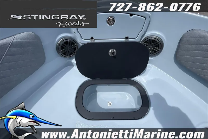 Slide: The Image of 2026 Stingray 23 OSX boat interior with storage compartment and speakers. - 19