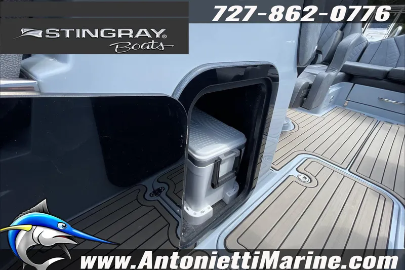 Slide: The Image of 2026 Stingray 23 OSX boat interior with storage compartment and seating. - 26