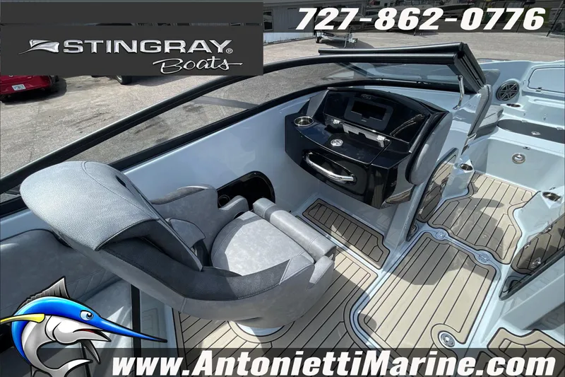 Slide: The Image of Interior view of 2026 Stingray 23 OSX boat with modern dashboard and seating. - 28