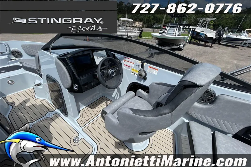 Slide: The Image of Interior view of 2026 Stingray 23 OSX boat with modern helm and seating. - 29