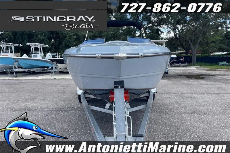 Slide: The Image of 2026 Stingray 23 OSX boat on trailer at Antonietti Marine dealership. - 3