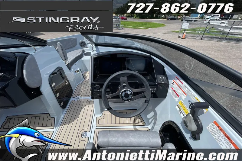 Slide: The Image of 2026 Stingray 23 OSX boat interior with steering wheel and dashboard, Antonietti Marine branding. - 30