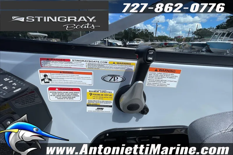 Slide: The Image of Control panel of 2026 Stingray 23 OSX boat with safety warnings and contact information. - 37