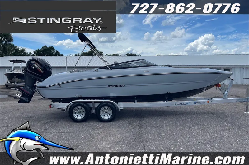 Slide: The Image of 2026 Stingray 23 OSX boat on trailer at Antonietti Marine dealership. - 5