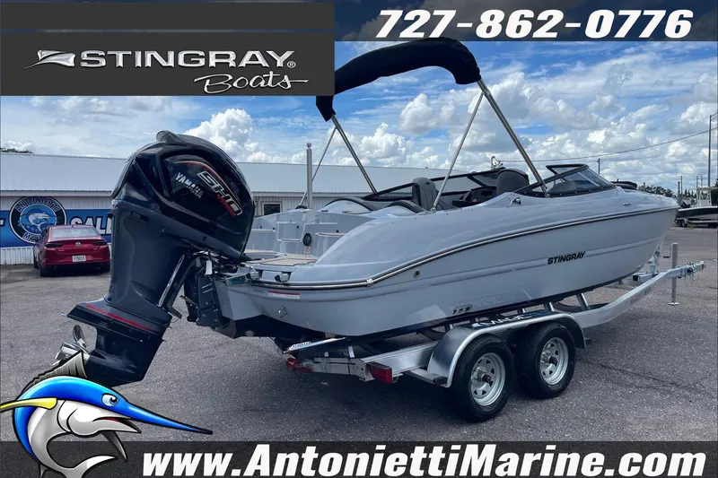 Slide: The Image of 2026 Stingray 23 OSX boat on trailer at Antonietti Marine dealership. - 6