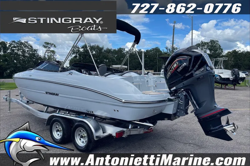 Slide: The Image of 2026 Stingray 23 OSX boat on trailer, displayed at Antonietti Marine dealership. - 8