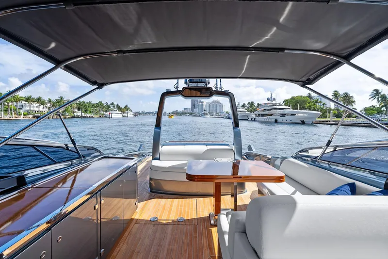 Slide: The Image of 2019 Riva 56 Rivale yacht interior with elegant seating and table, overlooking marina. - 11