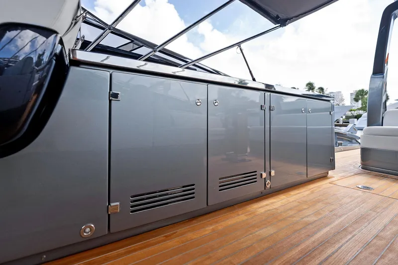 Slide: The Image of 2019 Riva 56 Rivale yacht deck with sleek cabinetry and wooden flooring. - 13