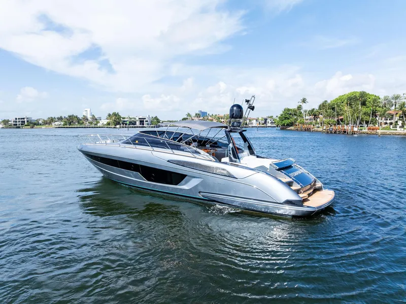 Slide: The Image of Luxurious 2019 Riva 56 Rivale yacht deck with polished wood table and seating. - 15