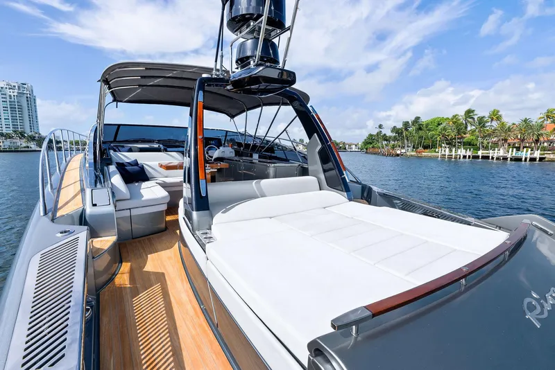 Slide: The Image of 2019 Riva 56 Rivale yacht with sun deck, cruising near luxury waterfront homes. - 22
