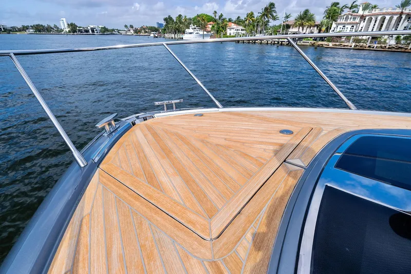 Slide: The Image of Bow of 2019 Riva 56 Rivale yacht with teak decking on a sunny day. - 26