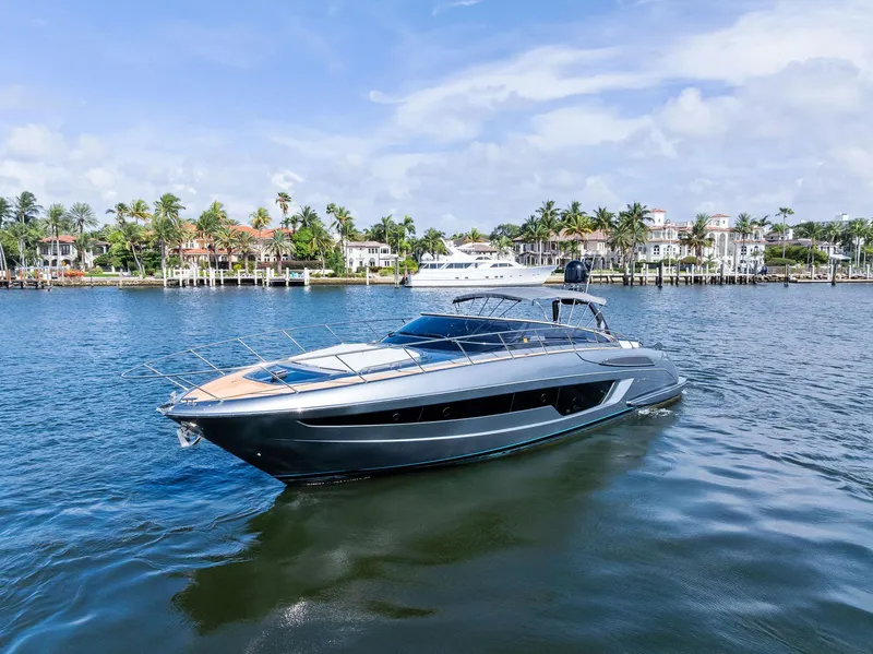Slide: The Image of 2019 Riva 56 Rivale yacht cruising on a sunny day near luxury waterfront homes. - 3