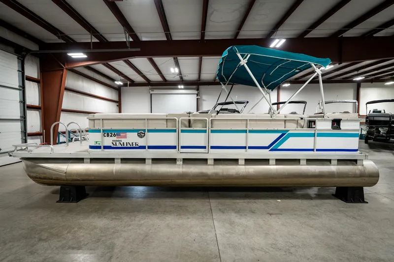 Slide: The Image of 1992 Harris FloteBote 240 Super Sunliner pontoon boat in indoor storage facility. - 10