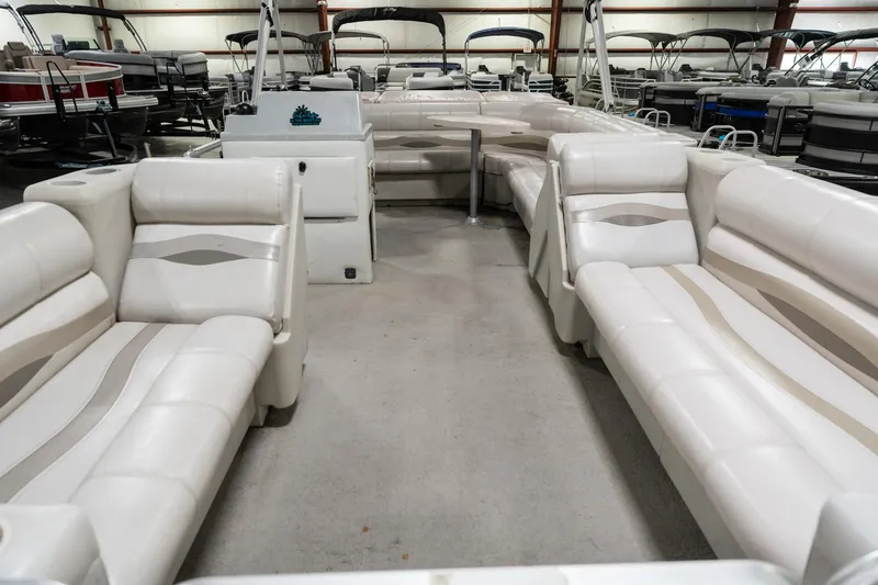 Slide: The Image of 1992 Harris FloteBote 240 Super Sunliner pontoon boat interior with white seating in showroom. - 15