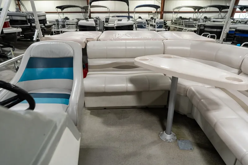 Slide: The Image of 1992 Harris FloteBote 240 Super Sunliner interior with white seating and table. - 17